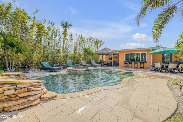 view of swimming pool with a patio, an in ground hot tub, a gazebo, an outdoor bar, and a fenced in pool