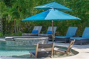 view of pool with a patio and an in ground hot tub