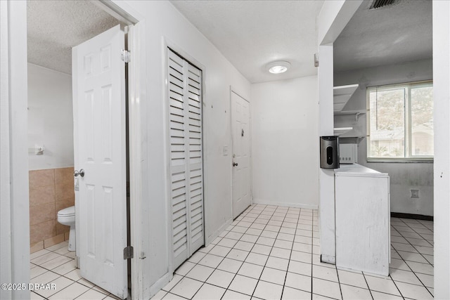 3548 Forest Branch Dr Unit C, Port Orange, FL 32129 - kitchen with light tile patterned flooring, a textured ceiling, and open shelves