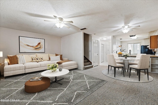 3548 Forest Branch Dr Unit C, Port Orange, FL 32129 - living room with a ceiling fan, stairs, carpet, and a textured ceiling