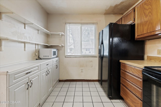 3548 Forest Branch Dr Unit C, Port Orange, FL 32129 - kitchen featuring open shelves, black appliances, light countertops, brown cabinetry, and light tile patterned floors