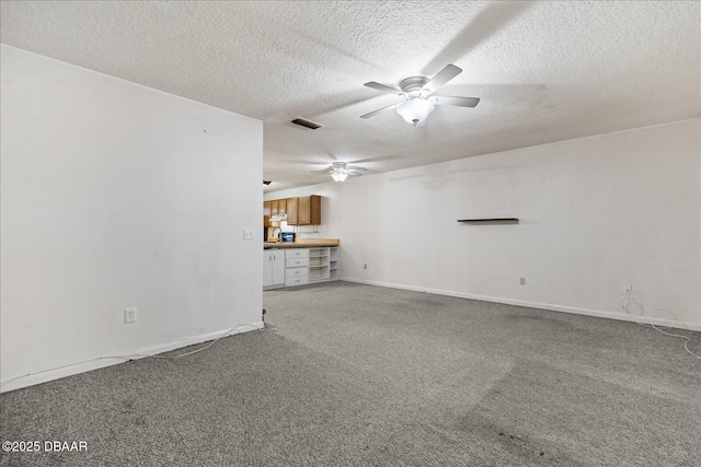 3548 Forest Branch Dr Unit C, Port Orange, FL 32129 - unfurnished living room with ceiling fan, carpet, and a textured ceiling