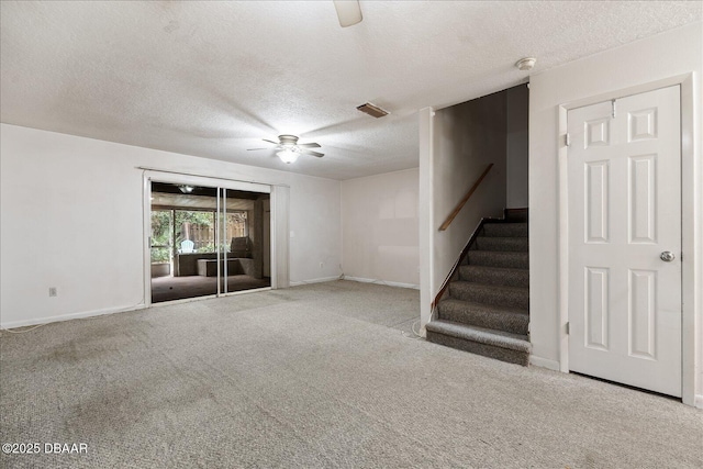 3548 Forest Branch Dr Unit C, Port Orange, FL 32129 - unfurnished living room featuring ceiling fan, a textured ceiling, carpet flooring, and stairs