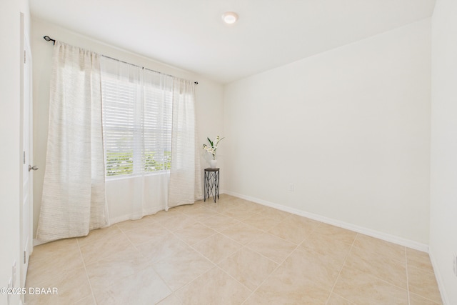 2625 Neverland Dr, New Smyrna Beach, FL 32168 - empty room featuring light tile patterned floors and baseboards