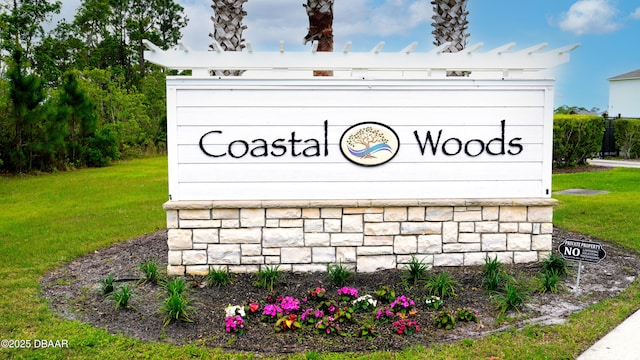 2625 Neverland Dr, New Smyrna Beach, FL 32168 - community / neighborhood sign featuring a lawn