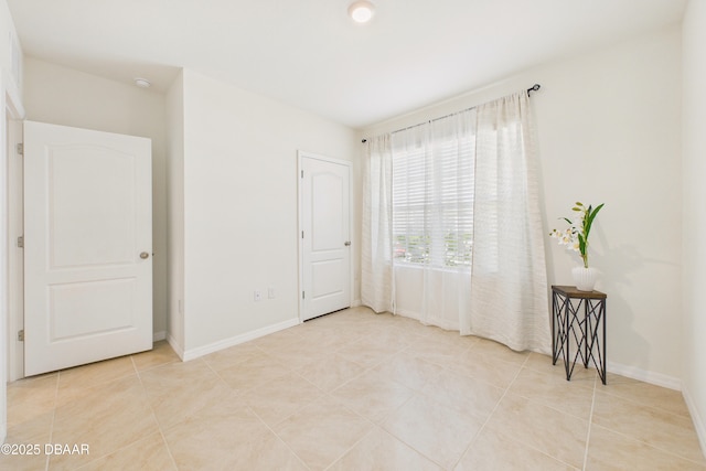 2625 Neverland Dr, New Smyrna Beach, FL 32168 - bedroom with light tile patterned floors and baseboards
