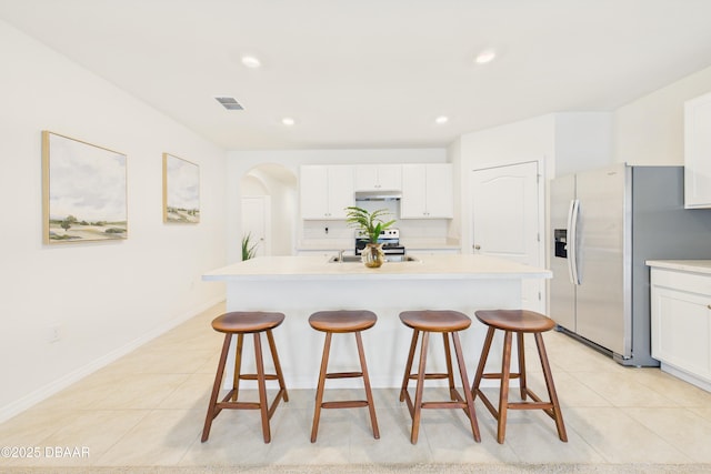 2625 Neverland Dr, New Smyrna Beach, FL 32168 - kitchen featuring stainless steel appliances, visible vents, a breakfast bar, and light tile patterned flooring