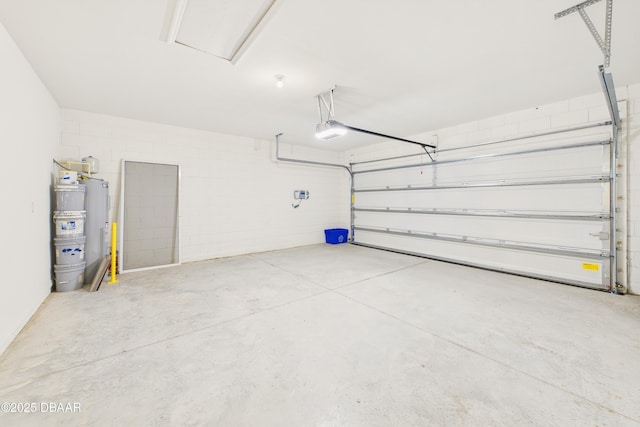 2625 Neverland Dr, New Smyrna Beach, FL 32168 - garage featuring water heater, concrete block wall, and a garage door opener