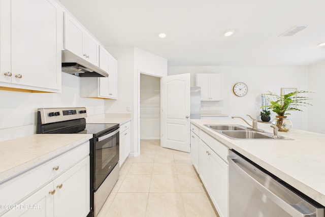 2625 Neverland Dr, New Smyrna Beach, FL 32168 - kitchen with visible vents, a sink, light countertops, under cabinet range hood, and stainless steel appliances