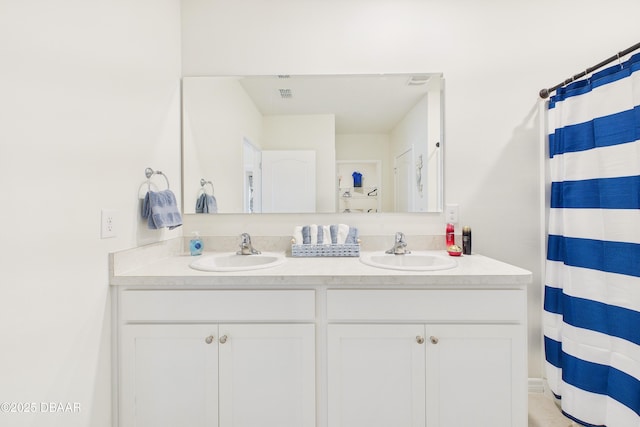 2625 Neverland Dr, New Smyrna Beach, FL 32168 - bathroom featuring a sink, double vanity, and a shower with curtain