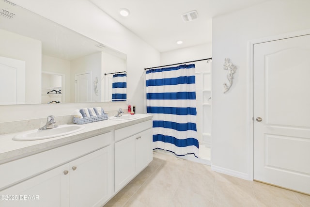 2625 Neverland Dr, New Smyrna Beach, FL 32168 - full bath with a sink, double vanity, and tile patterned flooring