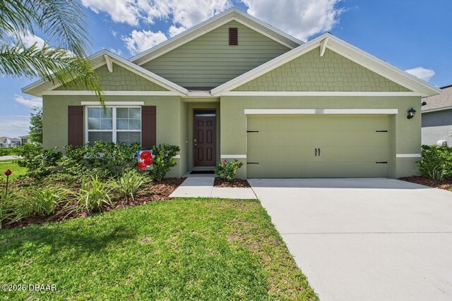 2625 Neverland Dr, New Smyrna Beach, FL 32168 - view of front of property featuring an attached garage, stucco siding, a front lawn, and concrete driveway