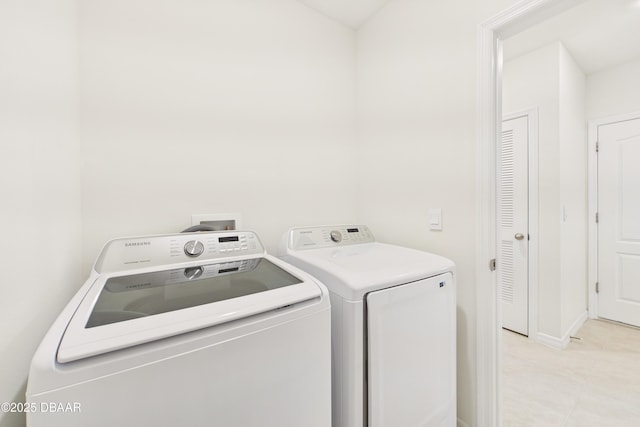 2625 Neverland Dr, New Smyrna Beach, FL 32168 - laundry area with washing machine and dryer, light tile patterned flooring, and laundry area