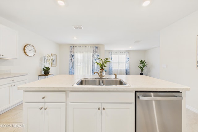 2625 Neverland Dr, New Smyrna Beach, FL 32168 - kitchen with light tile patterned floors, dishwasher, a sink, light countertops, and white cabinetry