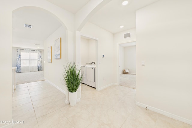 2625 Neverland Dr, New Smyrna Beach, FL 32168 - hallway with visible vents, independent washer and dryer, recessed lighting, and arched walkways