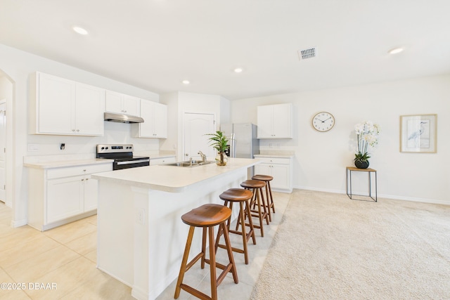 2625 Neverland Dr, New Smyrna Beach, FL 32168 - kitchen featuring fridge with ice dispenser, stainless steel range with electric stovetop, a sink, a breakfast bar, and under cabinet range hood