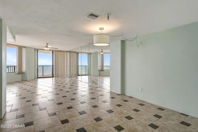 2425 S Atlantic Ave Unit 801, Daytona Beach Shores, FL 32118 - empty room featuring a ceiling fan, a pendent fire sprinkler, and floor to ceiling windows