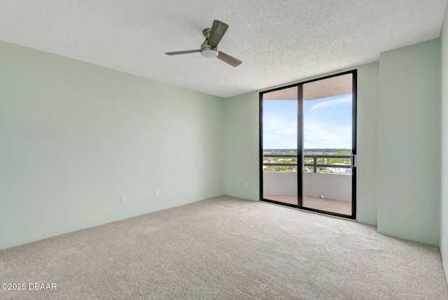 2425 S Atlantic Ave Unit 801, Daytona Beach Shores, FL 32118 - carpeted empty room featuring a wall of windows, ceiling fan, and a textured ceiling