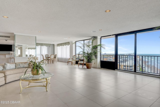 2425 S Atlantic Ave Unit 801, Daytona Beach Shores, FL 32118 - living room featuring a textured ceiling, floor to ceiling windows, tile patterned flooring, and recessed lighting
