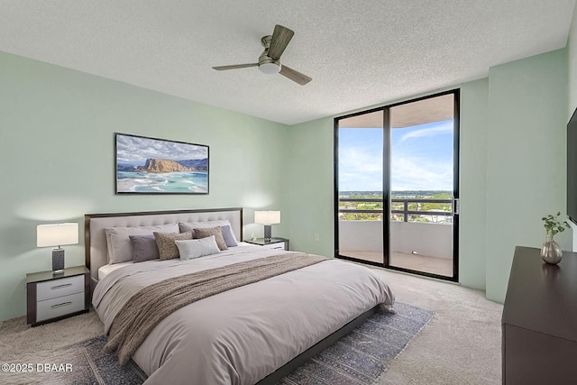 2425 S Atlantic Ave Unit 801, Daytona Beach Shores, FL 32118 - bedroom featuring expansive windows, light carpet, access to exterior, a textured ceiling, and ceiling fan