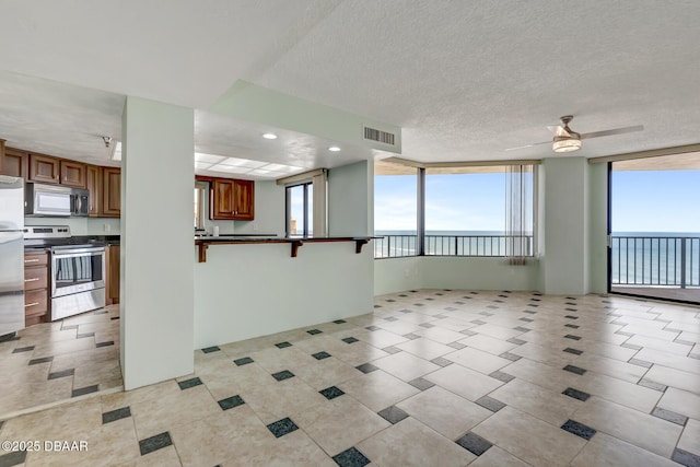 2425 S Atlantic Ave Unit 801, Daytona Beach Shores, FL 32118 - unfurnished living room with a ceiling fan, light tile patterned floors, recessed lighting, and a textured ceiling