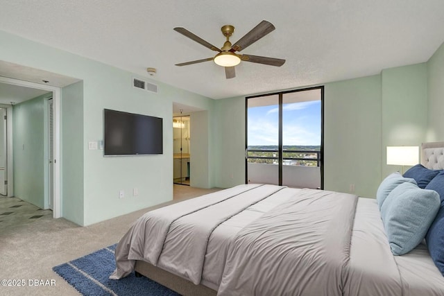 2425 S Atlantic Ave Unit 801, Daytona Beach Shores, FL 32118 - bedroom with light colored carpet, floor to ceiling windows, access to exterior, ceiling fan, and ensuite bathroom