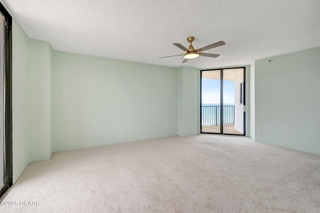 2425 S Atlantic Ave Unit 801, Daytona Beach Shores, FL 32118 - carpeted spare room with floor to ceiling windows, ceiling fan, and a textured ceiling