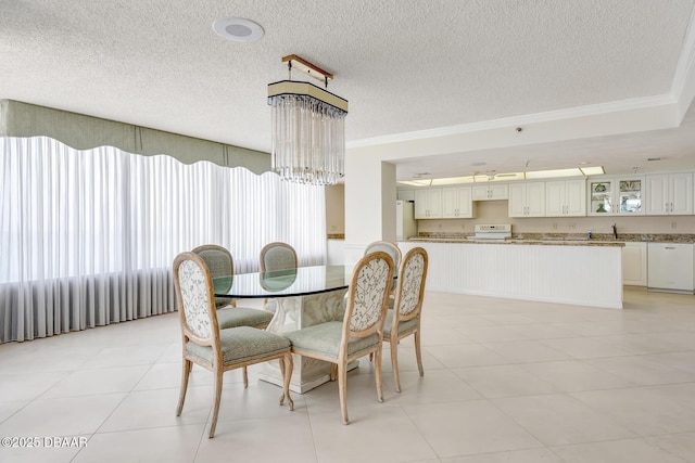 2425 S Atlantic Ave Unit 801, Daytona Beach Shores, FL 32118 - dining space with a textured ceiling, ornamental molding, a chandelier, and light tile patterned flooring
