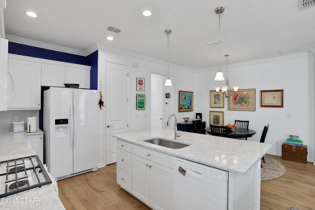 kitchen with visible vents, light wood-style flooring, white cabinets, a sink, and white appliances