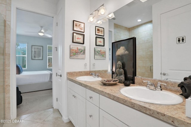 bathroom featuring a stall shower, double vanity, a sink, and tile patterned floors