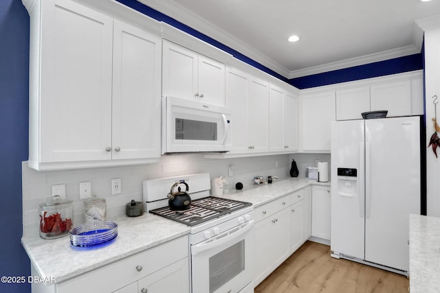 kitchen with crown molding, backsplash, light wood-style floors, white cabinetry, and white appliances