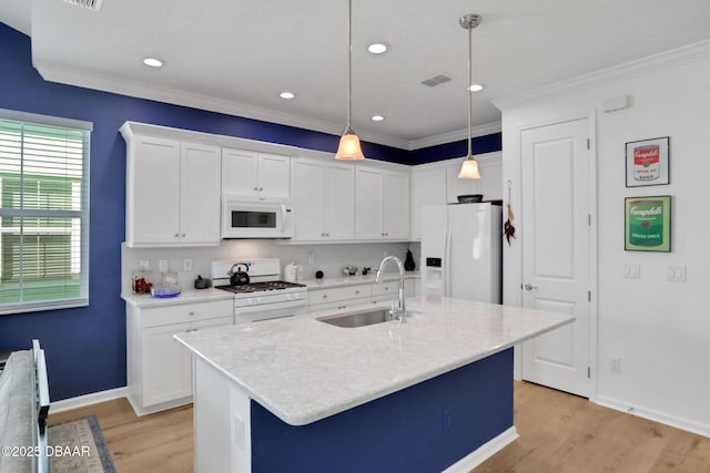 kitchen featuring white appliances, light wood-style flooring, visible vents, and a sink