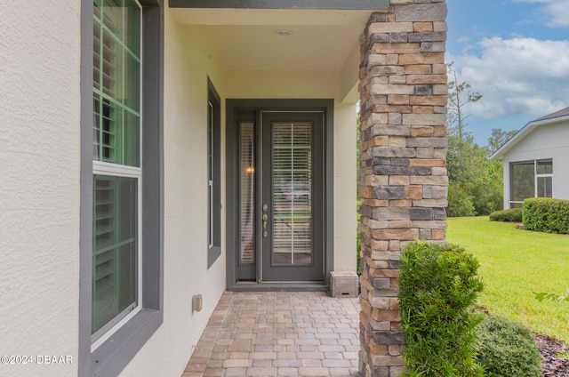 property entrance with a yard