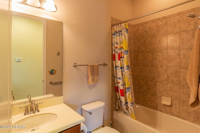 full bathroom with vanity, toilet, and shower / tub combo with curtain