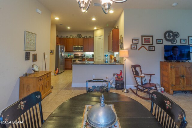 tiled dining area with a notable chandelier and sink