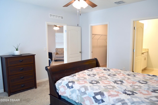 226 Meghan Cir, Deland, FL 32724 - bedroom with a walk in closet, a closet, light colored carpet, ensuite bath, and baseboards