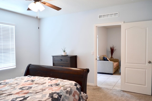 bedroom featuring ceiling fan and light colored carpet