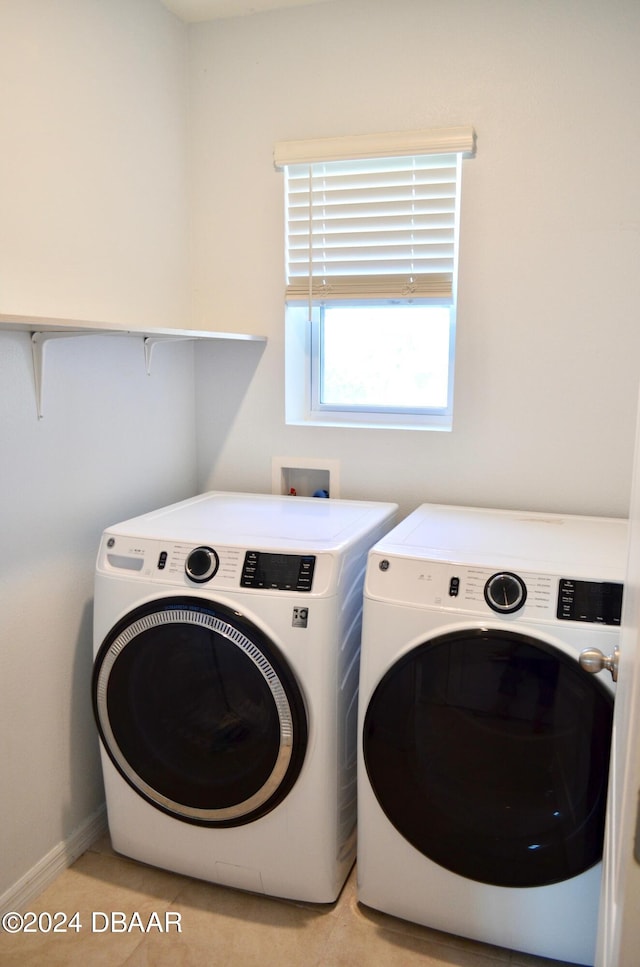 washroom with washing machine and dryer and light tile patterned floors