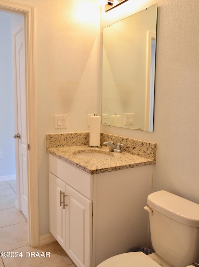 bathroom with tile patterned flooring, vanity, and toilet