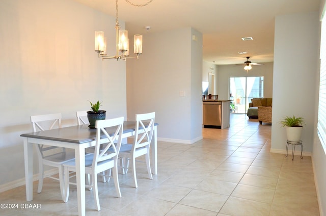 dining space featuring light tile patterned floors and ceiling fan with notable chandelier