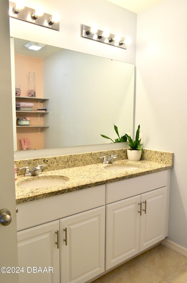 226 Meghan Cir, Deland, FL 32724 - bathroom with double vanity, tile patterned floors, and baseboards