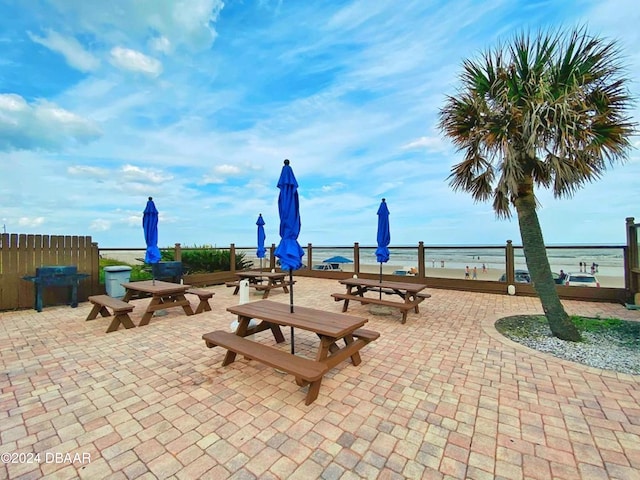 view of community with a water view and a patio area