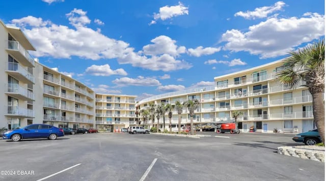 view of building exterior with uncovered parking