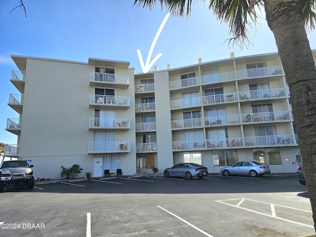 view of building exterior with uncovered parking