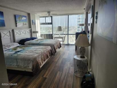 bedroom with dark hardwood / wood-style flooring and a textured ceiling