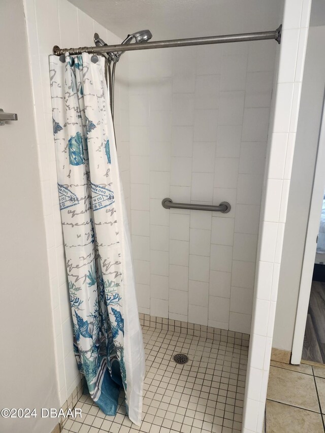 bathroom with tile patterned flooring and a shower with curtain