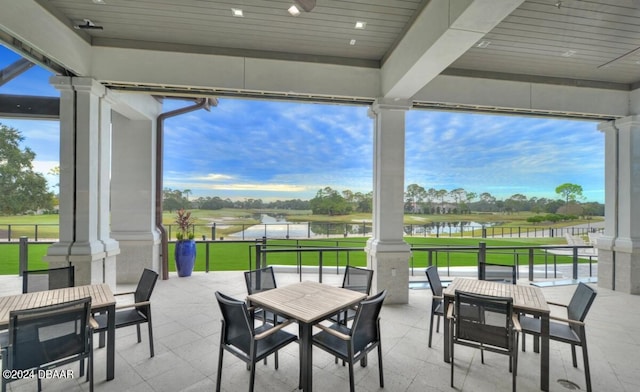 view of patio / terrace with a water view and ceiling fan