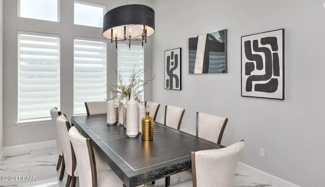 dining area featuring a healthy amount of sunlight and a chandelier