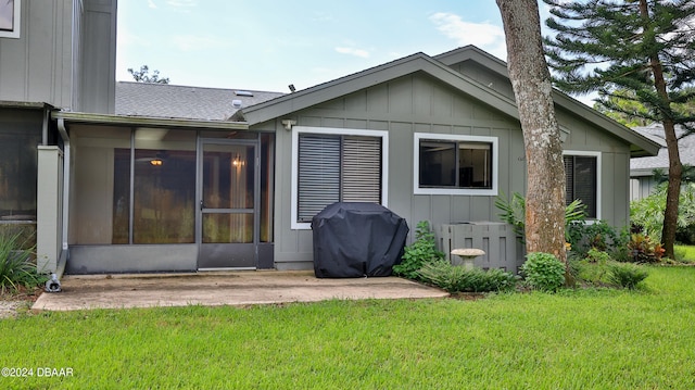 rear view of property with a sunroom and a yard