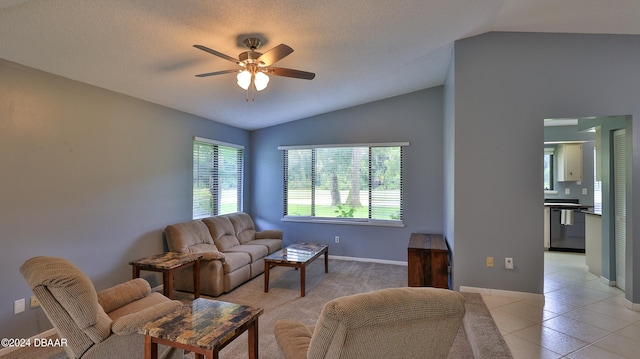 tiled living room featuring ceiling fan, a textured ceiling, and lofted ceiling